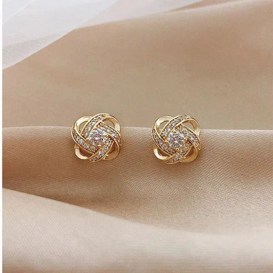 Boucles d'oreilles spiralées en cristal doré avec motif floral